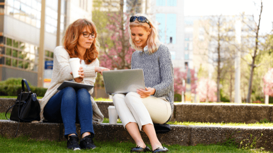 two ladies working on laptops